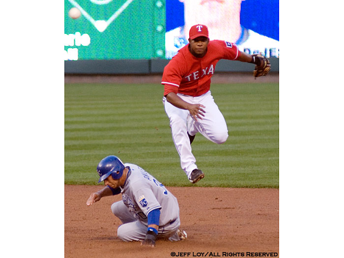 Texas Rangers shortstop Elvis Andrus attempts to turn a double play after tagging Kansas City's Mike Aviles.