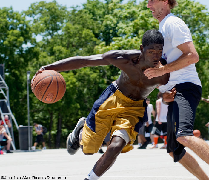 Roderick Johnson drives toward the basked during the Hoop-It-Up Tournament at Fair Park in Dallas, Texas.